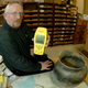 ** ADVANCE FOR WEEKEND OF APRIL 5-6 ** Kevin T. Jones Archaeologist for the State of Utah, poses with a GPS receiver while sitting next to a 1,000 year old Fremont Indian pot and other artifacts in his lab in Salt Lake City, Wednesday, April 2, 2003. There are concerns that with GPS coordinates and a map anyone can find artifacts that are normally hidden or hard to find, leaving ancient, priceless art vulnerable to what the Bureau of Land Management calls "digital vandalism."